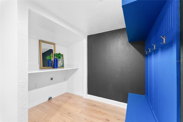 laundry room with laundry area, wood finished floors, baseboards, and electric dryer hookup