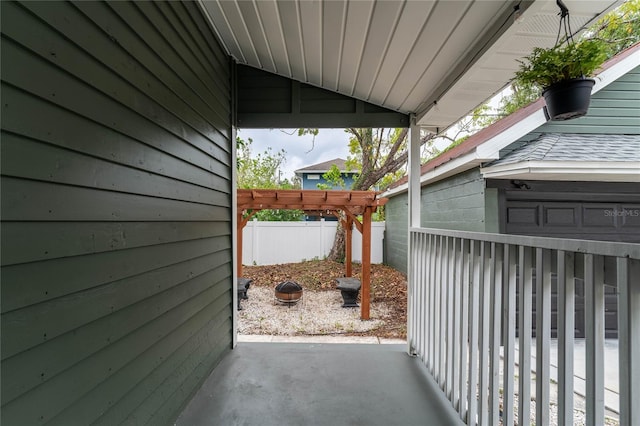 view of patio with a pergola and fence