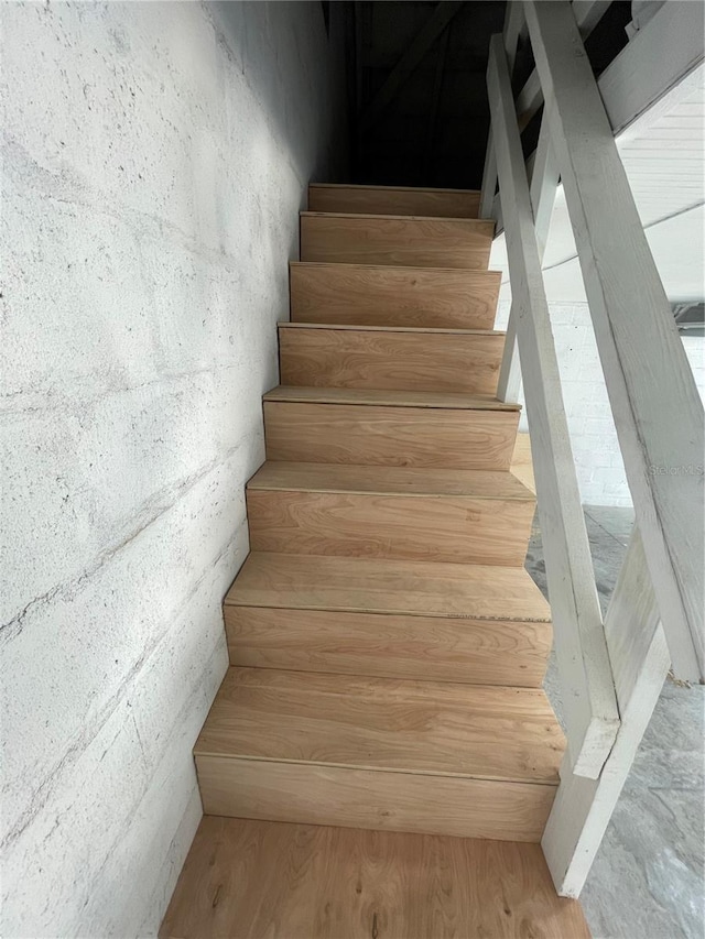 stairs featuring wood finished floors