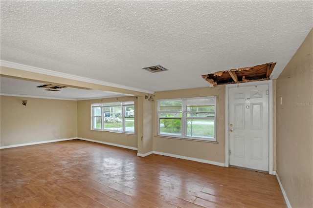 empty room featuring hardwood / wood-style floors and a textured ceiling