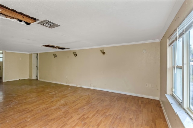 unfurnished room featuring wood-type flooring and crown molding