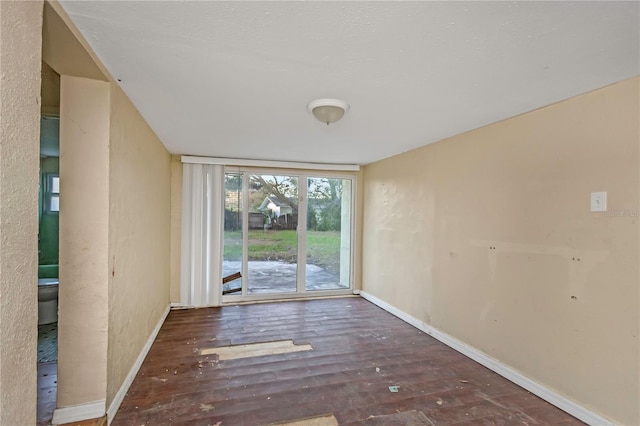 spare room with dark wood-type flooring