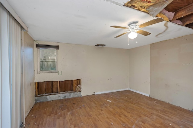 empty room featuring ceiling fan and hardwood / wood-style flooring