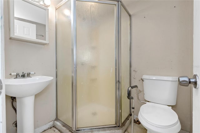 bathroom featuring sink, toilet, and walk in shower