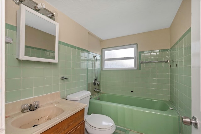 full bathroom featuring vanity, tiled shower / bath combo, and toilet