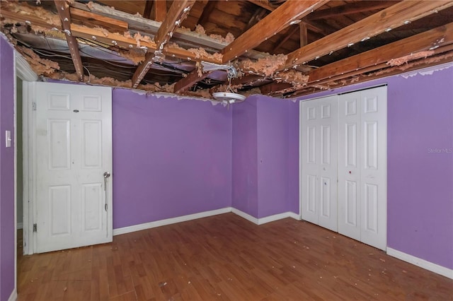 basement with dark hardwood / wood-style flooring