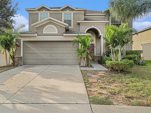 2411 Birds Eye Ct, Ruskin, FL 33570 - view of front of home with driveway, stucco siding, a garage, and stone siding