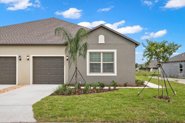 view of front of house featuring a garage and a front lawn