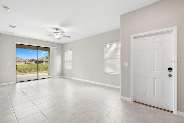 unfurnished room featuring light tile patterned flooring and ceiling fan