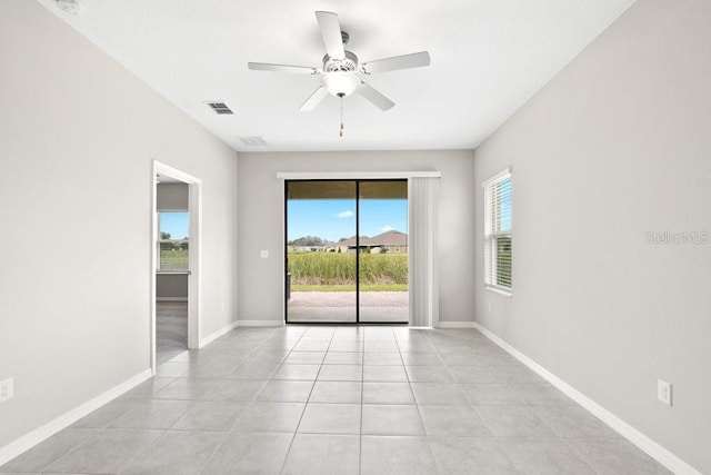 spare room featuring ceiling fan and light tile patterned flooring