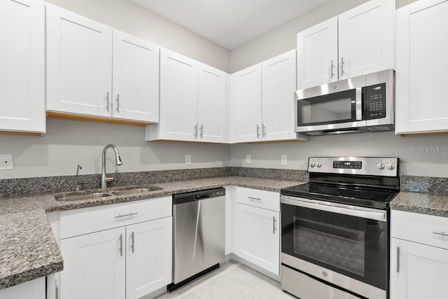 kitchen featuring white cabinetry, appliances with stainless steel finishes, and sink