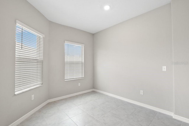 unfurnished room featuring light tile patterned floors