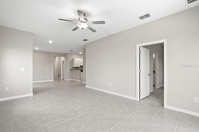 unfurnished room featuring ceiling fan and light tile patterned floors