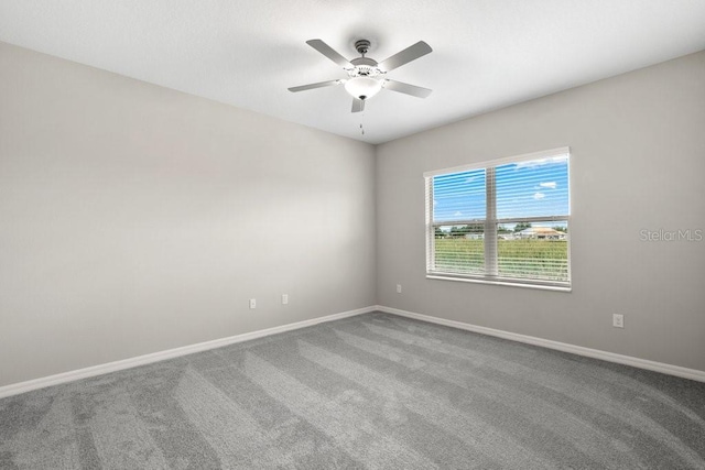 empty room featuring carpet flooring and ceiling fan