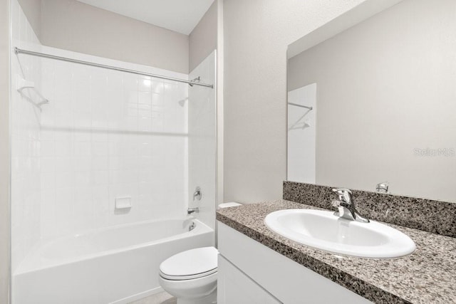 full bathroom featuring vanity, tiled shower / bath, and toilet