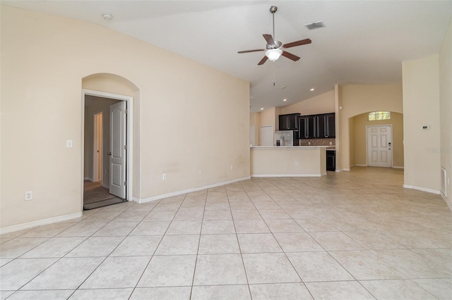 unfurnished living room featuring light tile patterned floors, vaulted ceiling, and ceiling fan