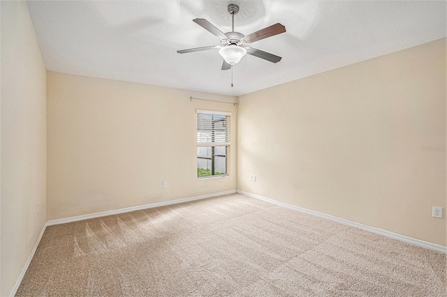 unfurnished room featuring light colored carpet and ceiling fan