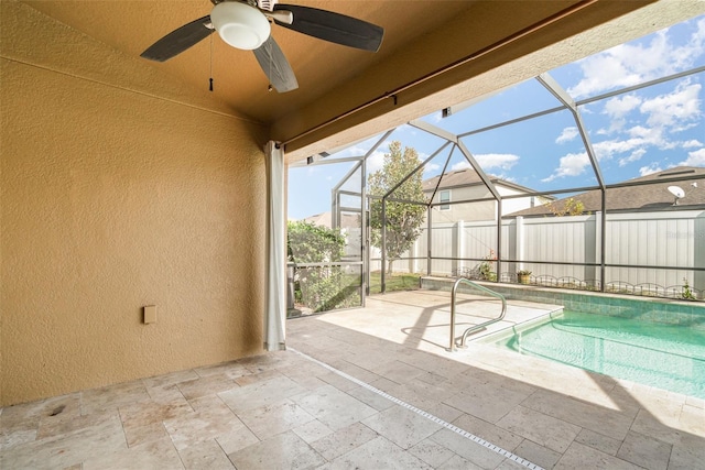 view of pool featuring a patio area, ceiling fan, and glass enclosure