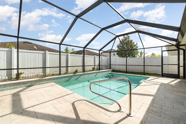 view of swimming pool featuring a patio area and a lanai