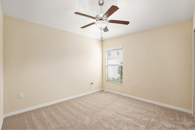 unfurnished room with ceiling fan and light colored carpet