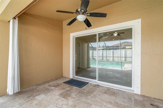 property entrance with ceiling fan and a patio