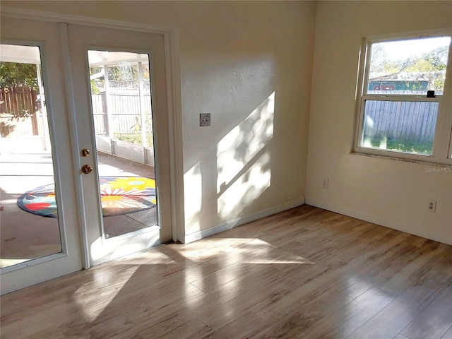 doorway with light hardwood / wood-style flooring and french doors