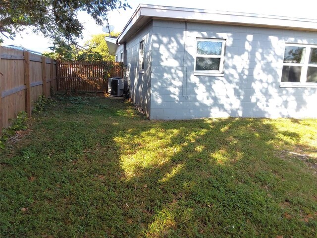 view of home's exterior with central AC unit and a yard