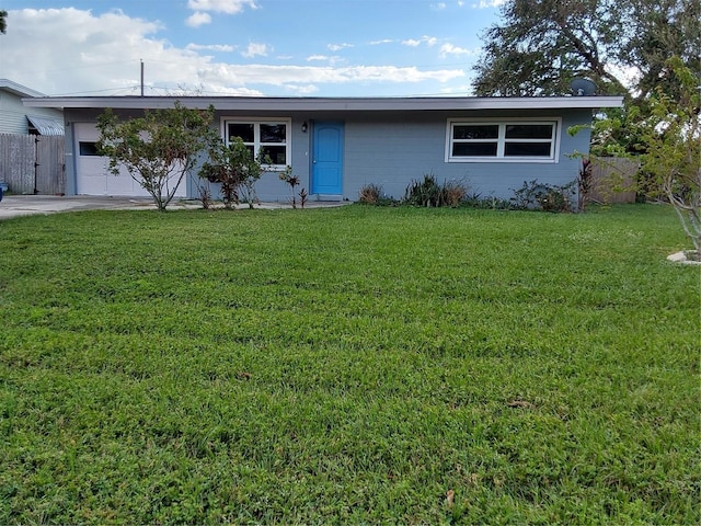 ranch-style home featuring a garage and a front yard