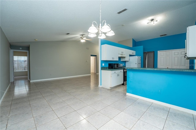 kitchen featuring white cabinets, hanging light fixtures, ceiling fan with notable chandelier, and vaulted ceiling