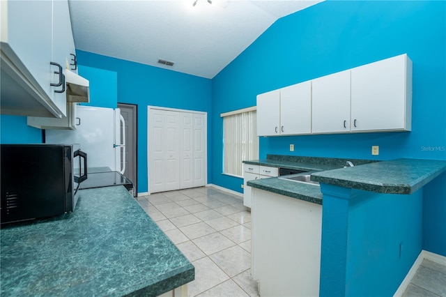 kitchen featuring light tile patterned flooring, white cabinetry, extractor fan, and sink