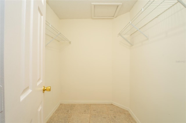 spacious closet with light tile patterned floors