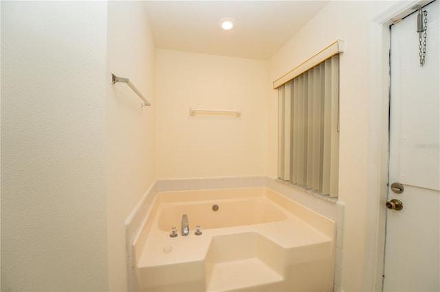 bathroom with a tub to relax in