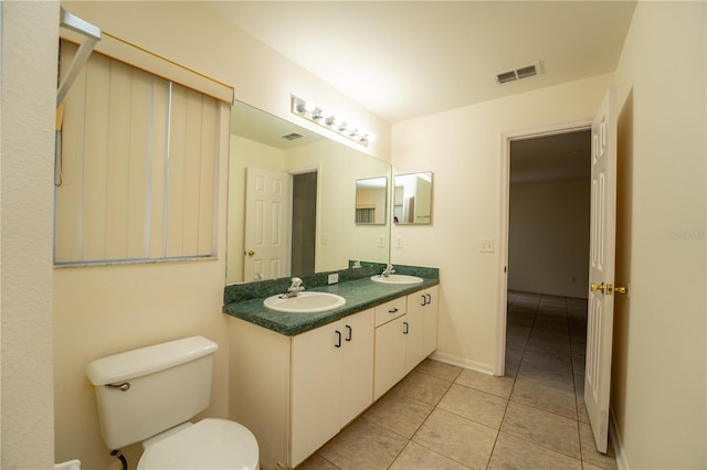 bathroom with vanity, tile patterned floors, and toilet