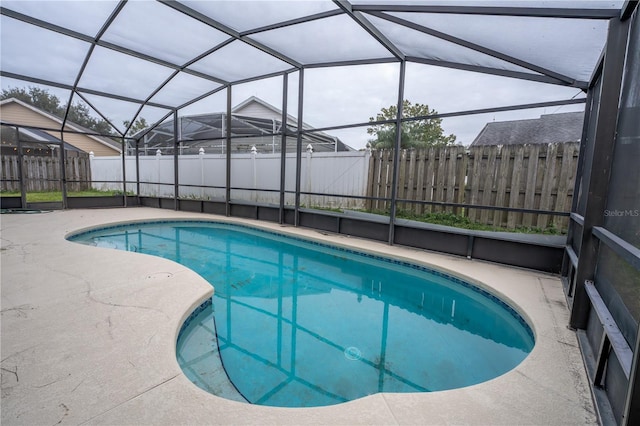 view of pool with a lanai and a patio area