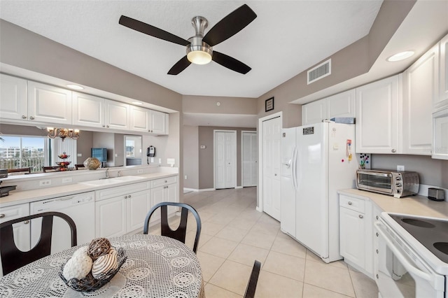 kitchen featuring white cabinets, white appliances, sink, and light tile patterned flooring