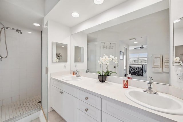 bathroom featuring vanity, ceiling fan, tile patterned floors, and tiled shower