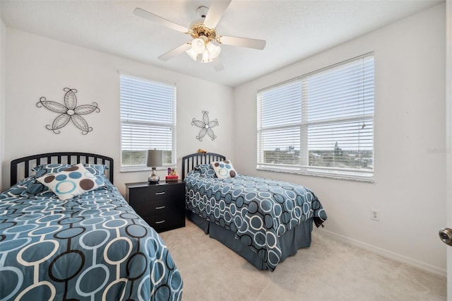 carpeted bedroom featuring ceiling fan and multiple windows