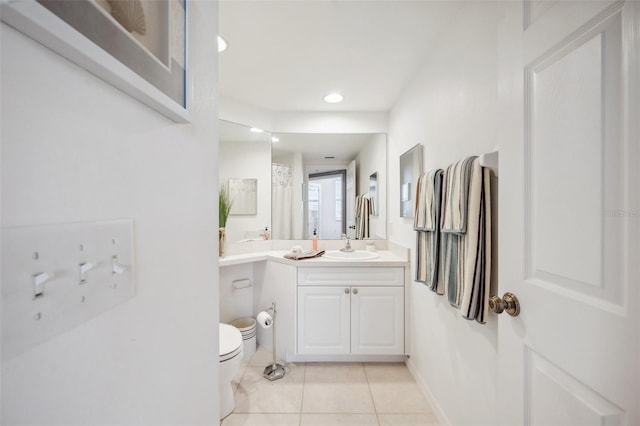 bathroom with tile patterned flooring, curtained shower, vanity, and toilet