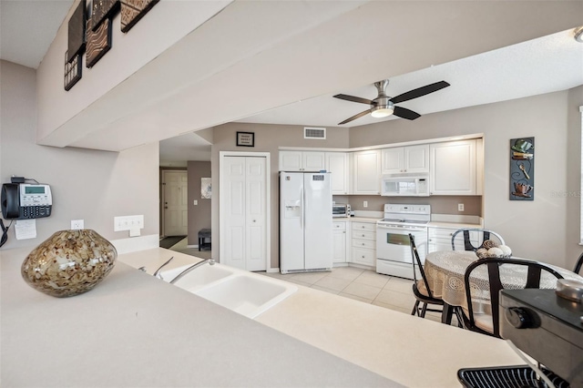 kitchen featuring light tile patterned floors, sink, ceiling fan, white cabinetry, and white appliances