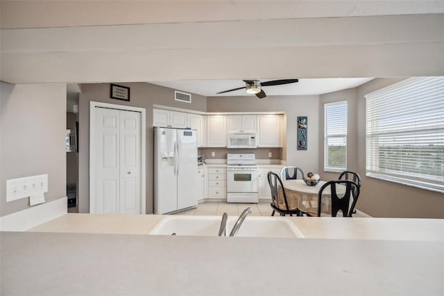 kitchen featuring white cabinetry, white appliances, ceiling fan, and light tile patterned flooring