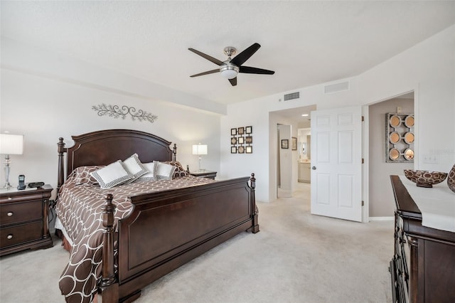 carpeted bedroom with ceiling fan and ensuite bath