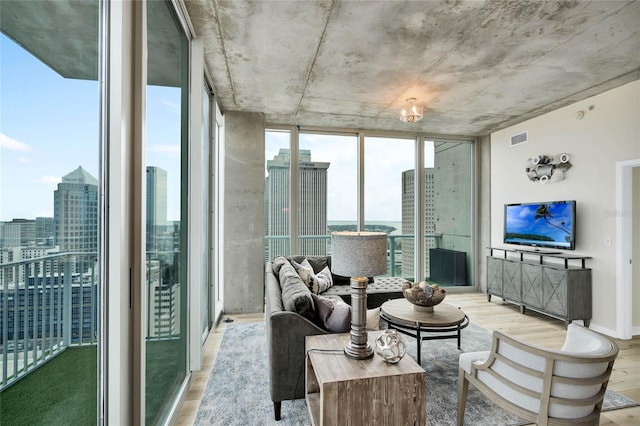 living room featuring expansive windows and light wood-type flooring