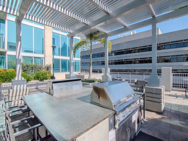 view of patio / terrace with a grill, a pergola, and exterior kitchen