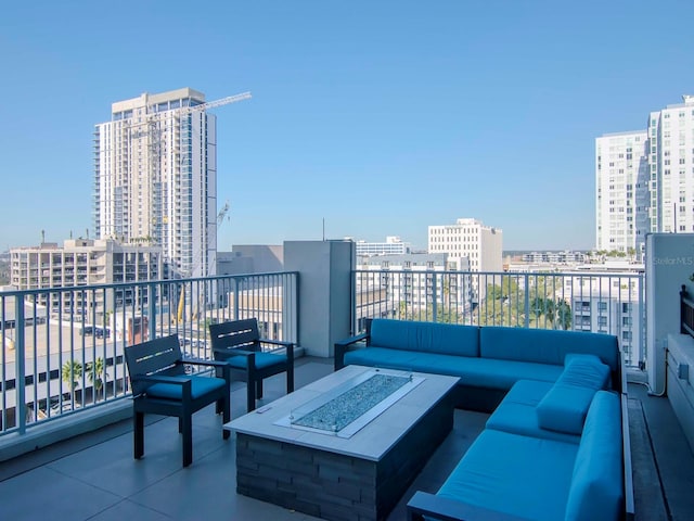 balcony featuring an outdoor living space with a fire pit