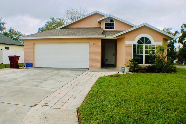 view of front of house featuring a garage and a front yard