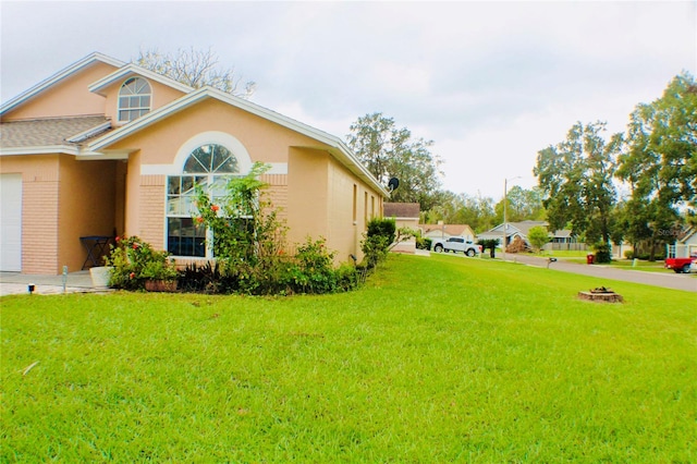 view of side of property with a yard