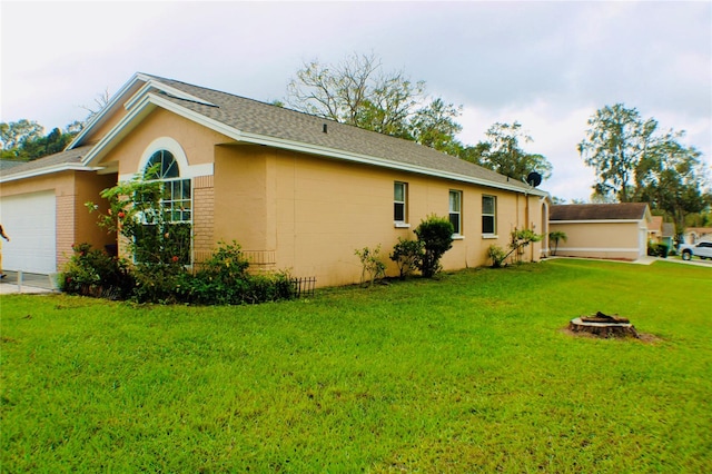 exterior space with a garage and a yard