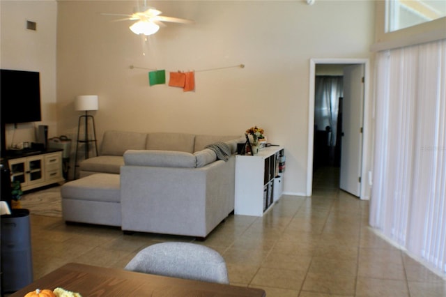 tiled living room featuring a towering ceiling and ceiling fan