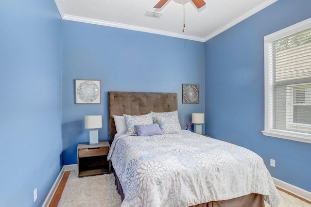 bedroom featuring ceiling fan, light wood-type flooring, and ornamental molding