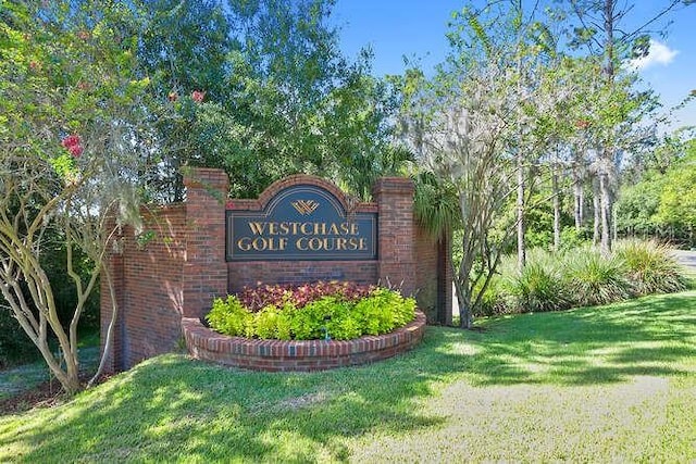 community / neighborhood sign with a yard